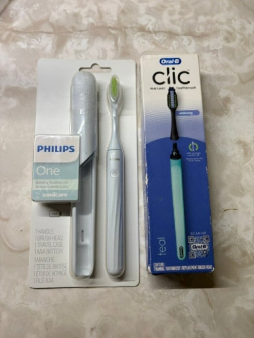 (1) Philips Sonicare Battery Toothbrush and (1) Oral-B Clic Manual Toothbrush